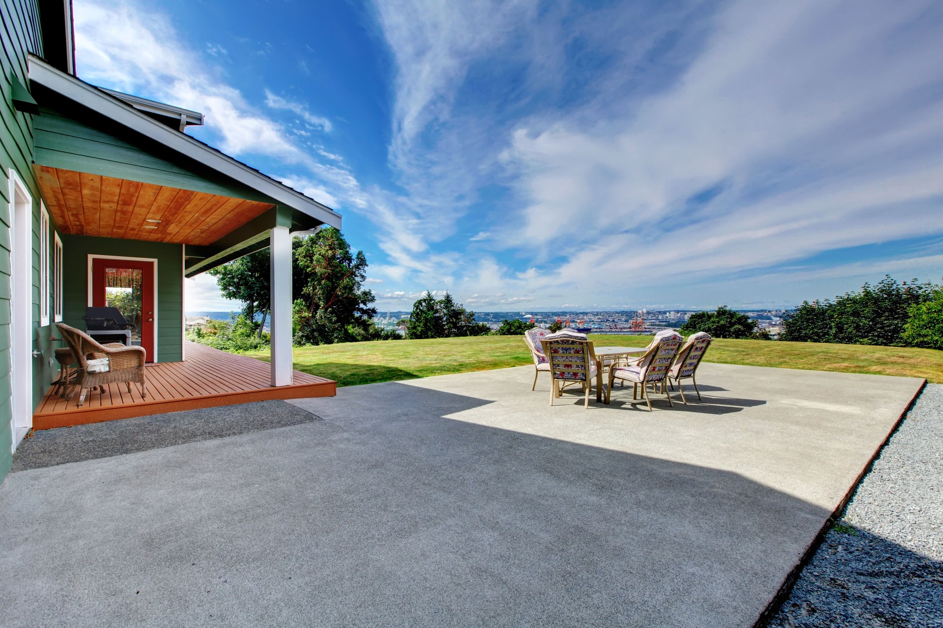 VIew of large concrete floor patio area at backyard